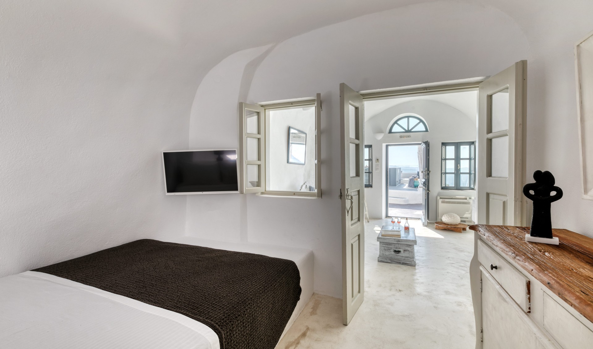 The lavish double bed offered from Nostos Apartments in Oia Santorini